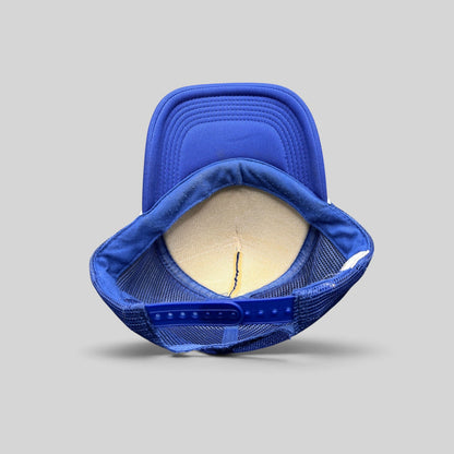 Raree Finds vintage royal blue trucker hat showing the interior foam lining, mesh back, and adjustable snapback strap.