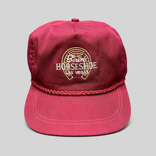 Raree Finds vintage burgundy cotton strapback hat with embroidered Binion’s Horseshoe Las Vegas logo and rope detail.
