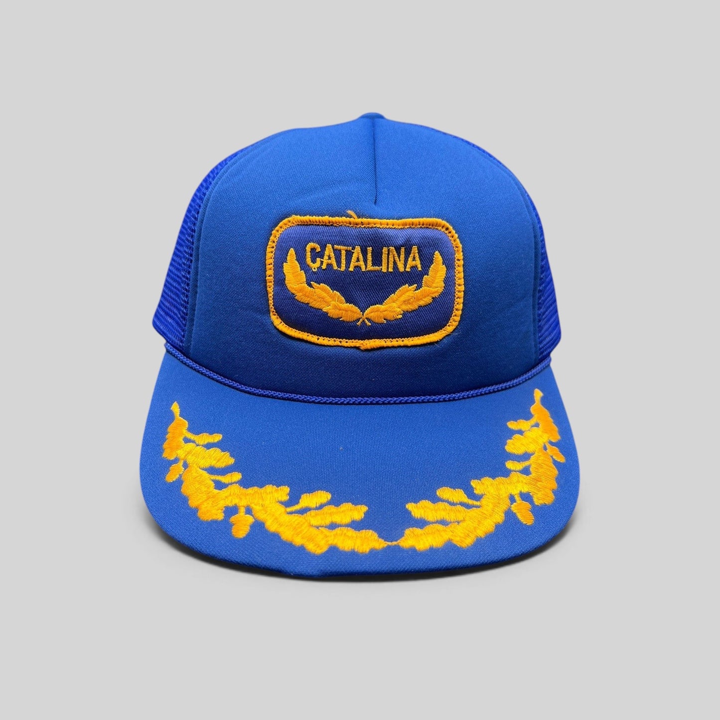 Raree Finds vintage 1980s royal blue foam trucker hat with gold Catalina patch and embroidered laurel brim detail