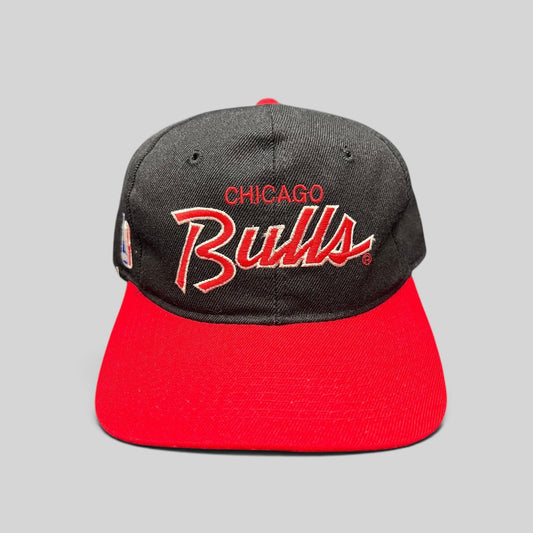 Raree Finds vintage 90s Chicago Bulls snapback hat with red and white script embroidery on a black crown and red brim