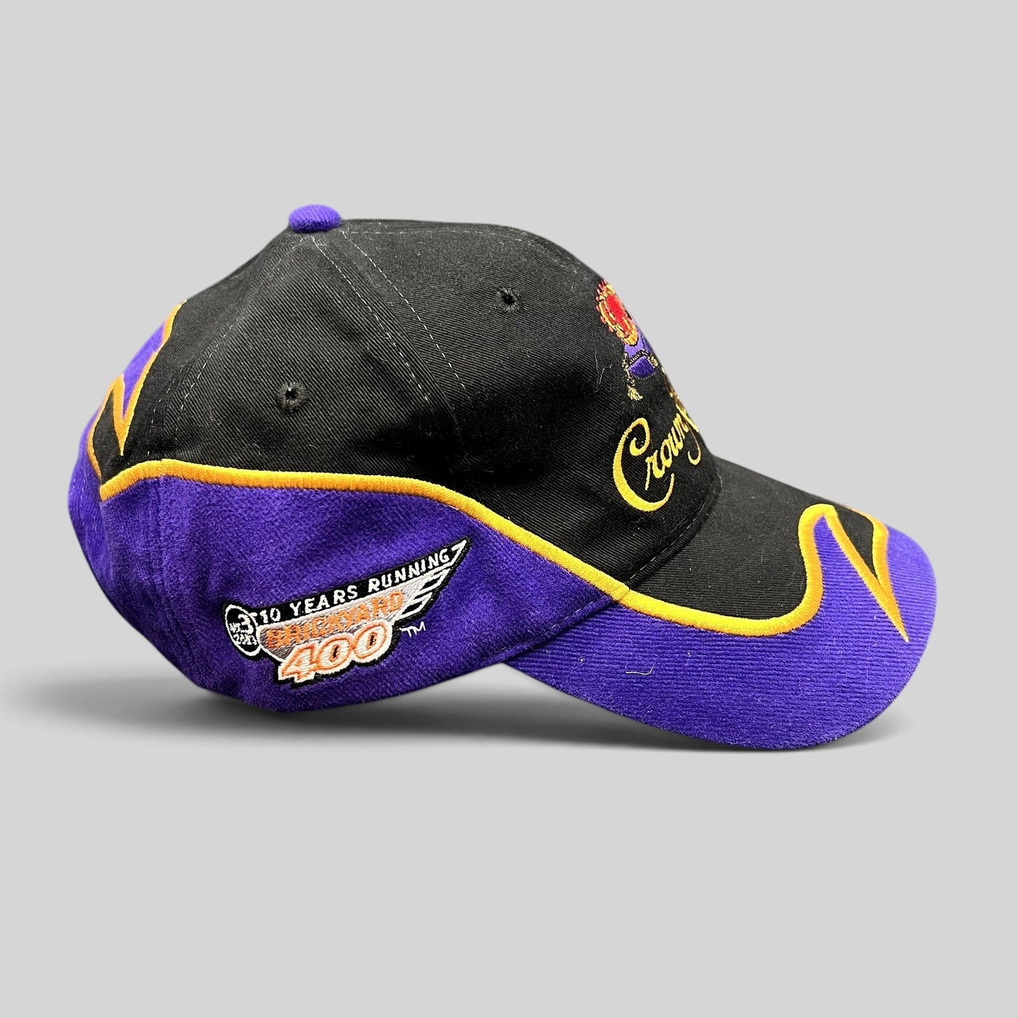 Raree Finds vintage 2003 Crown Royal Roots strapback hat in black and purple with gold embroidered racing graphics