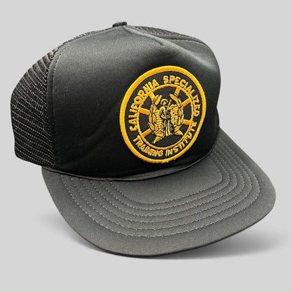 Raree Finds vintage black foam trucker hat with a gold California Specialized Training Institute embroidered patch.