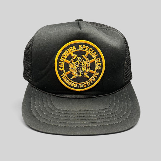 Raree Finds vintage black foam trucker hat with a gold California Specialized Training Institute embroidered patch.