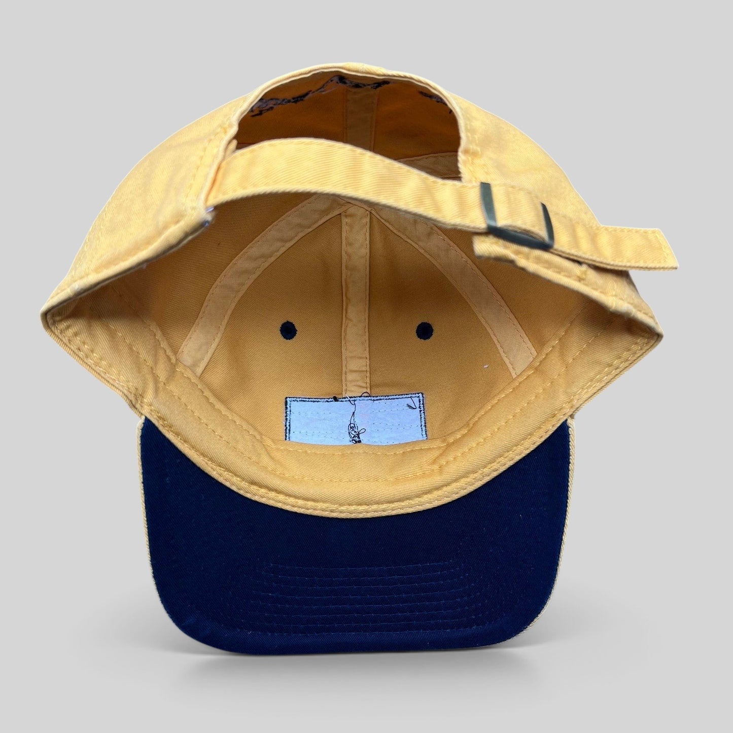 Raree Finds vintage Walt Disney World yellow cotton strapback hat with metal buckle closure, interior view