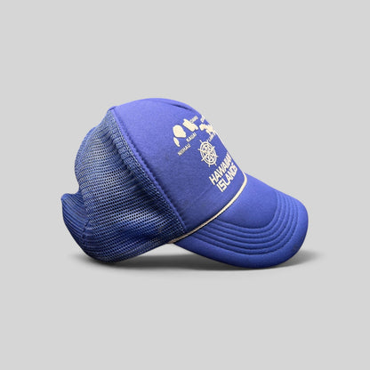 Raree Finds vintage royal blue foam trucker hat with a white Hawaiian Islands map graphic and nautical helm emblem.