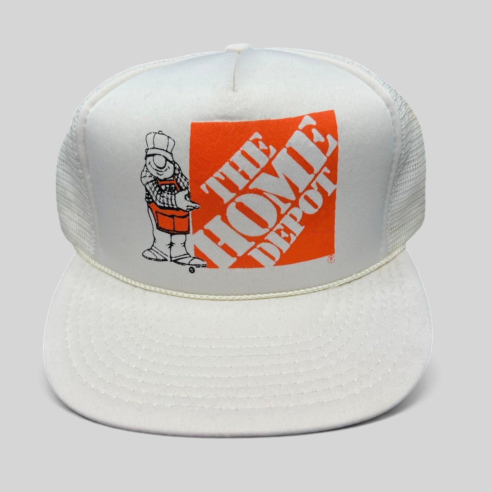 Raree Finds vintage 80s white and orange Home Depot trucker snapback hat with worker mascot graphic and mesh back