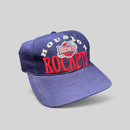 Raree Finds vintage 1990s Houston Rockets snapback hat in navy blue with red embroidered logo and green undervisor