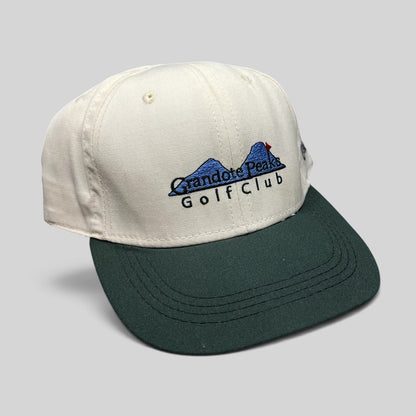 Raree Finds vintage 1997 Imperial Headwear two-tone white and green golf cap with Grandote Peaks Golf Club embroidery