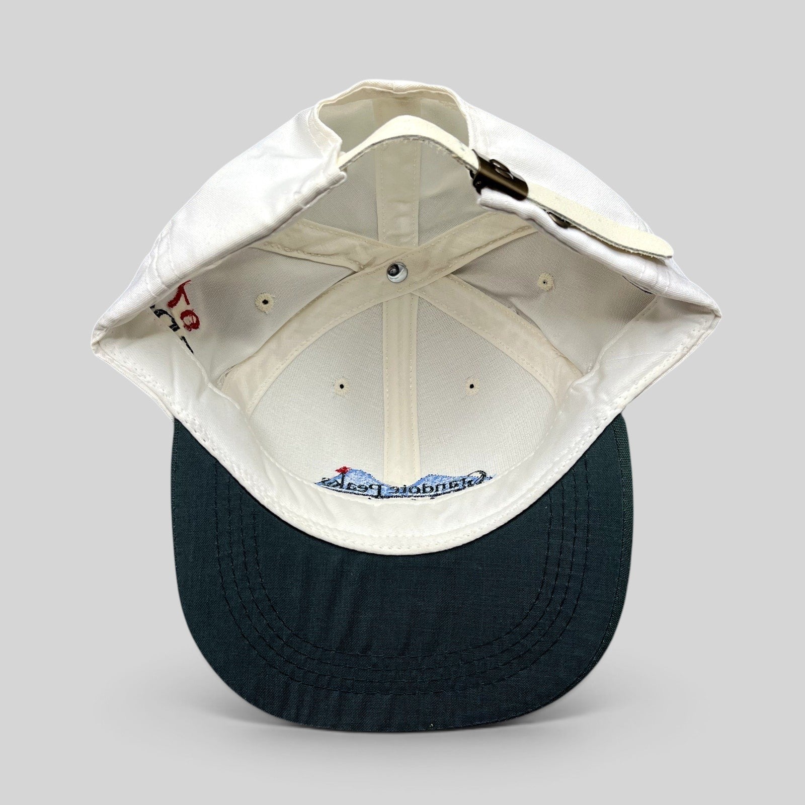 Raree Finds vintage 1997 Imperial golf hat featuring a white crown, green brim, and adjustable brass buckle strapback.