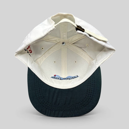 Raree Finds vintage 1997 Imperial golf hat featuring a white crown, green brim, and adjustable brass buckle strapback.