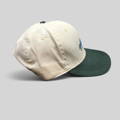 Raree Finds vintage 1997 Imperial two-tone white and green golf strapback hat with embroidered logo side profile