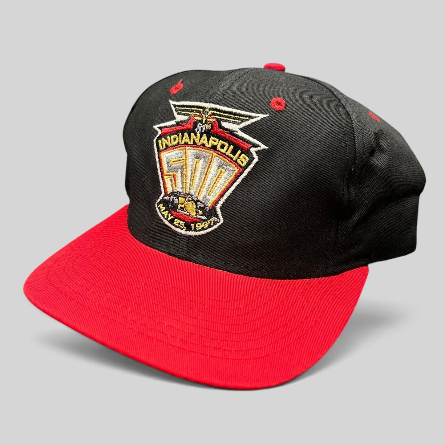 Raree Finds vintage 1997 Indianapolis 500 snapback hat with black crown, red brim, and embroidered race logo.