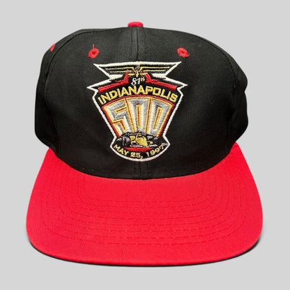 Raree Finds vintage 1997 Indianapolis 500 snapback hat with black crown, red brim, and embroidered racing logo.