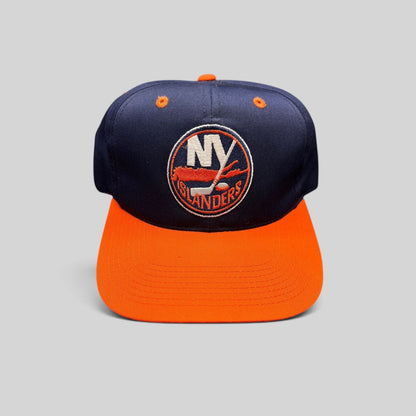 Raree Finds vintage 1990s New York Islanders snapback hat in navy and orange with embroidered team logo.