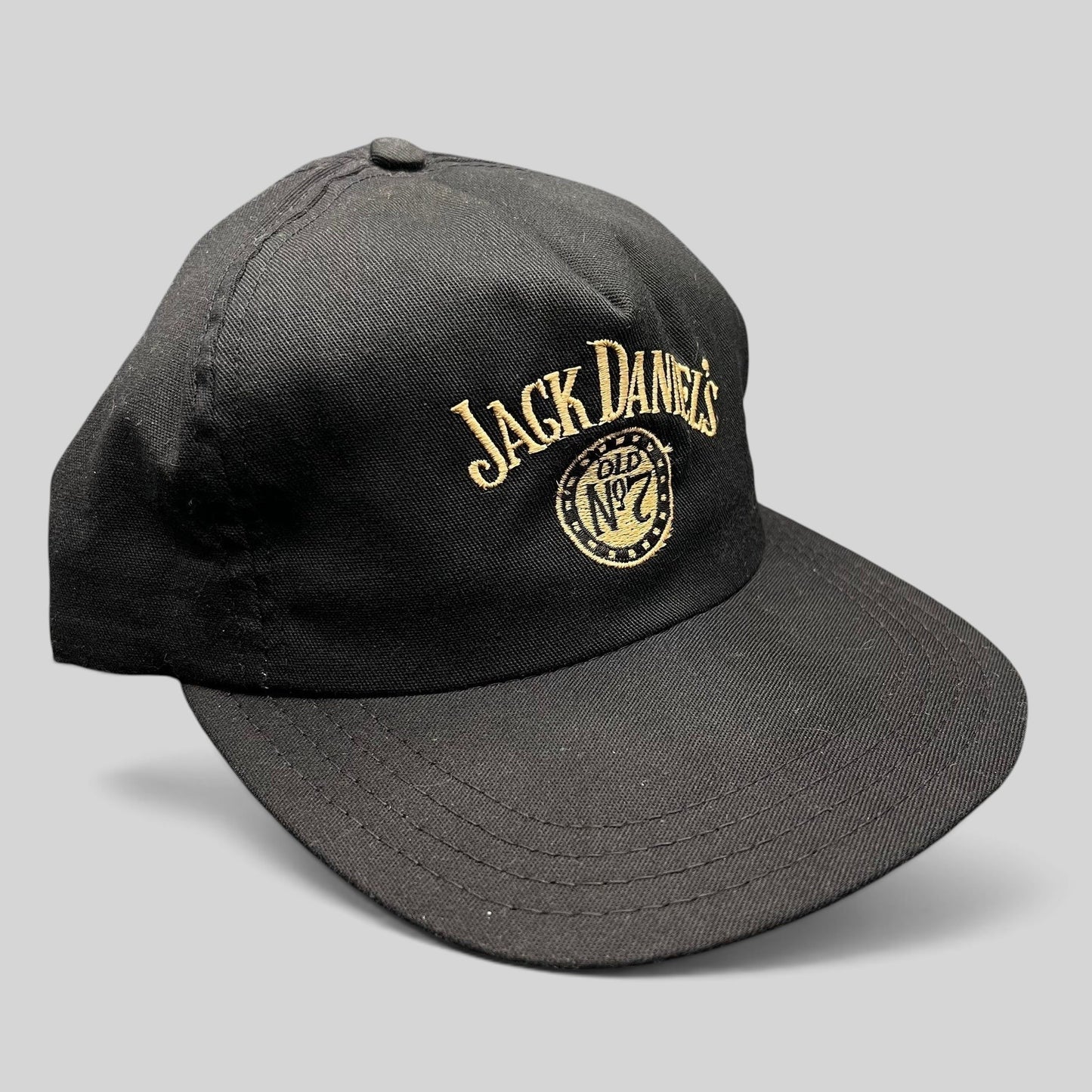 Raree Finds vintage 90s Jack Daniel’s black snapback hat with gold embroidered Old No. 7 logo and arched script