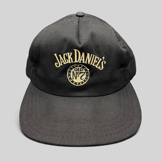 Raree Finds vintage 90s black Jack Daniel’s Old No. 7 snapback hat with gold embroidered logo and structured crown.