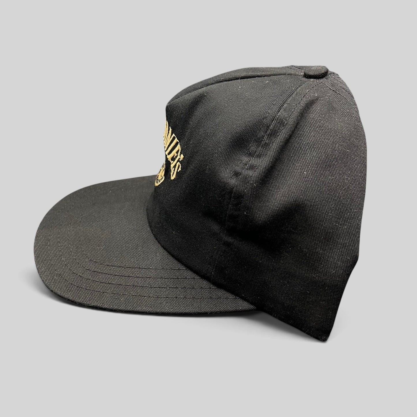 Raree Finds vintage 90s Jack Daniel’s black snapback hat with gold embroidered Old No. 7 logo on a six-panel crown.