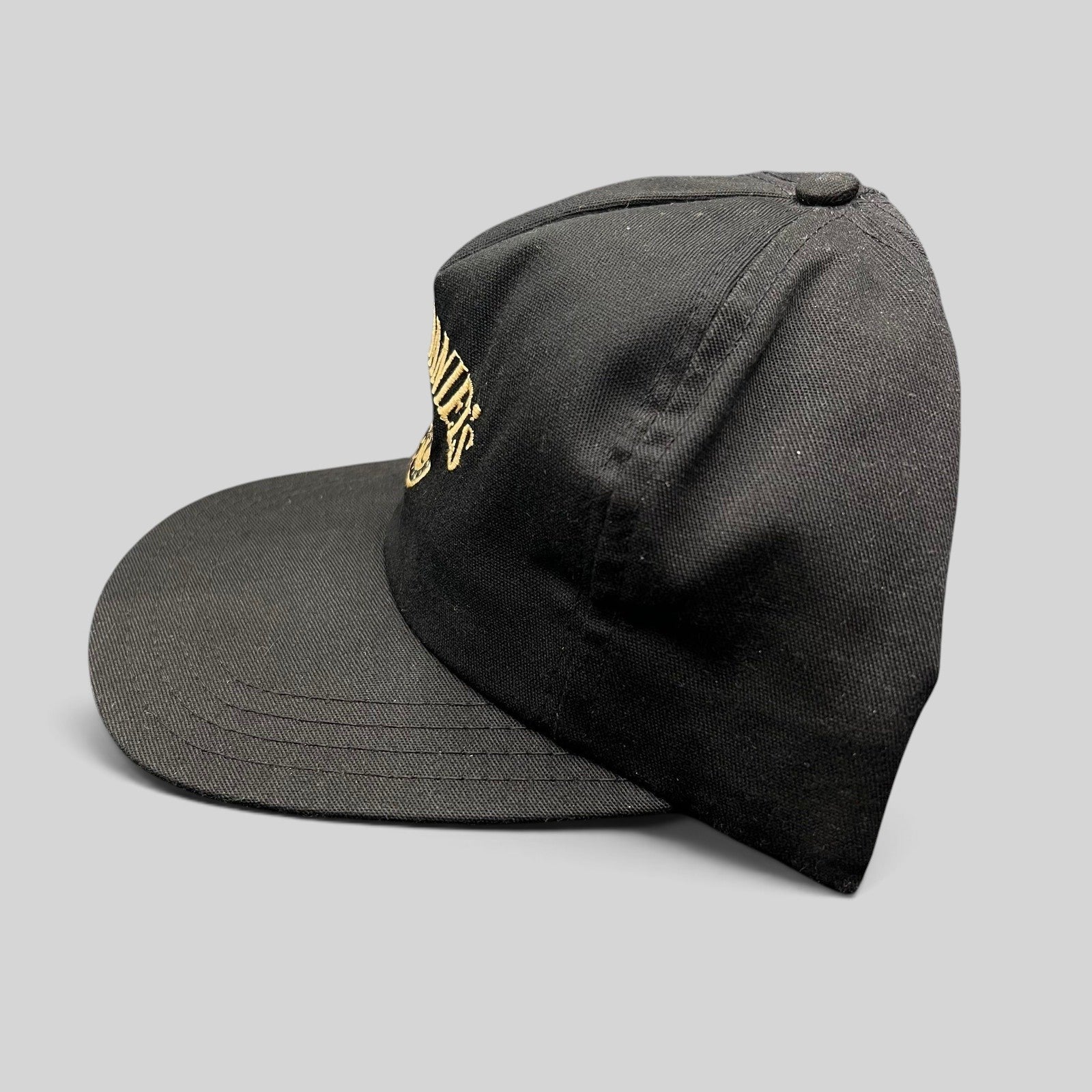 Raree Finds vintage 90s Jack Daniel’s black snapback hat with gold embroidered Old No. 7 logo on a six-panel crown.