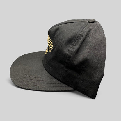 Raree Finds vintage 90s Jack Daniel’s black snapback hat with gold embroidered Old No. 7 logo on a six-panel crown.