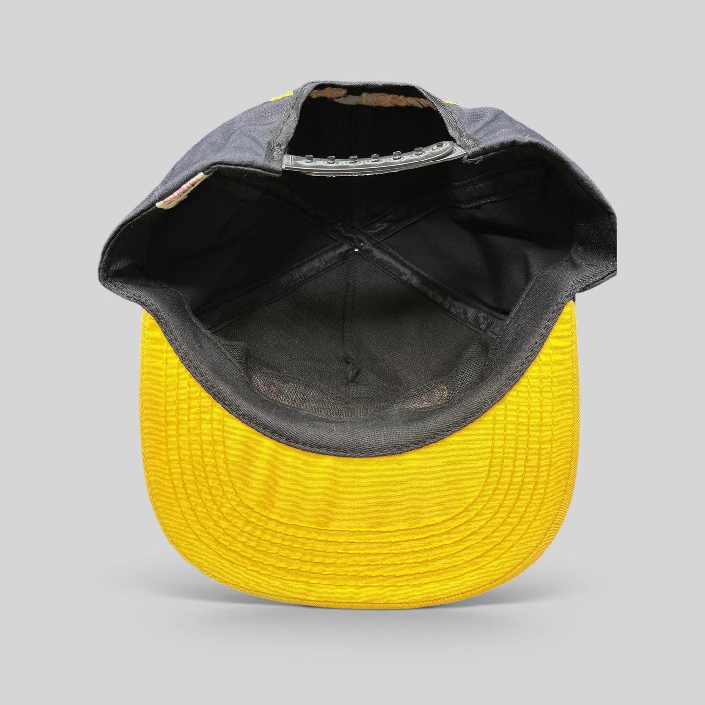 Raree Finds vintage Jose Cuervo snapback hat interior view showing black crown, yellow brim, and adjustable strap.