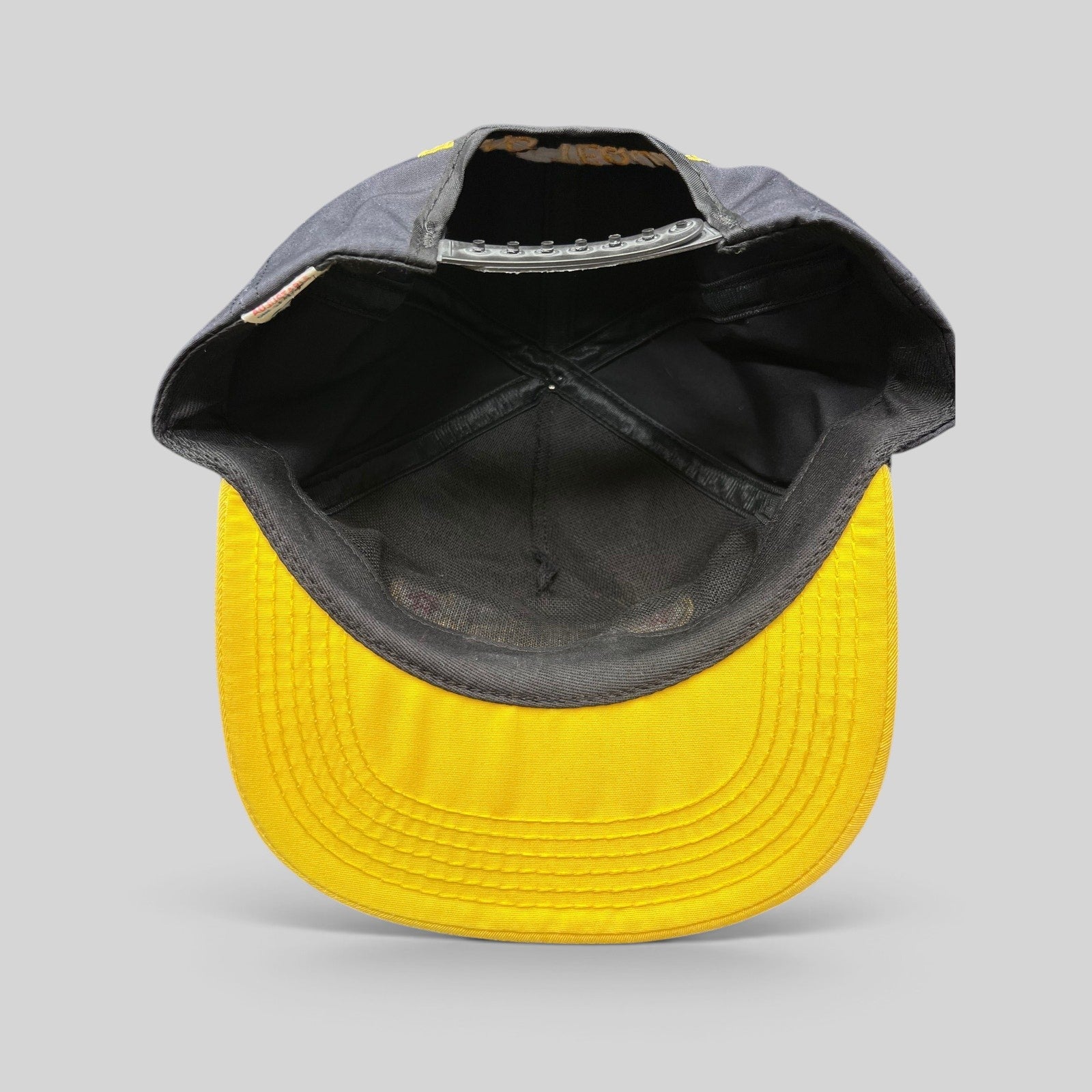 Raree Finds vintage Jose Cuervo snapback hat interior view showing black crown, yellow brim, and adjustable strap.