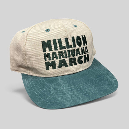 Raree Finds vintage 90s Million Marijuana March snapback hat with a cream textured crown and green brim.
