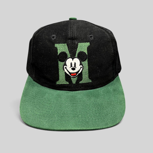 Raree Finds vintage 90s Disney Store black and green snapback hat with embroidered Mickey Mouse M logo on flat brim