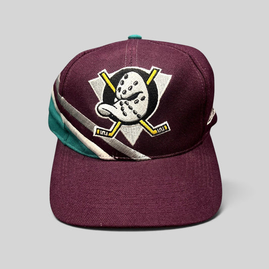 Raree Finds vintage Apex One Anaheim Mighty Ducks snapback hat in purple with a teal and silver wave design