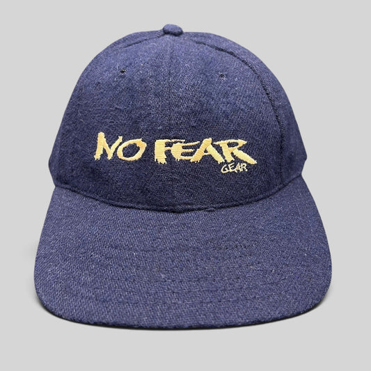 Raree Finds vintage 90s navy wool-blend snapback hat with gold No Fear Gear embroidery and structured six-panel design.