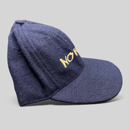 Raree Finds vintage 90s navy wool-blend snapback hat with gold No Fear Gear embroidery and structured six-panel design.