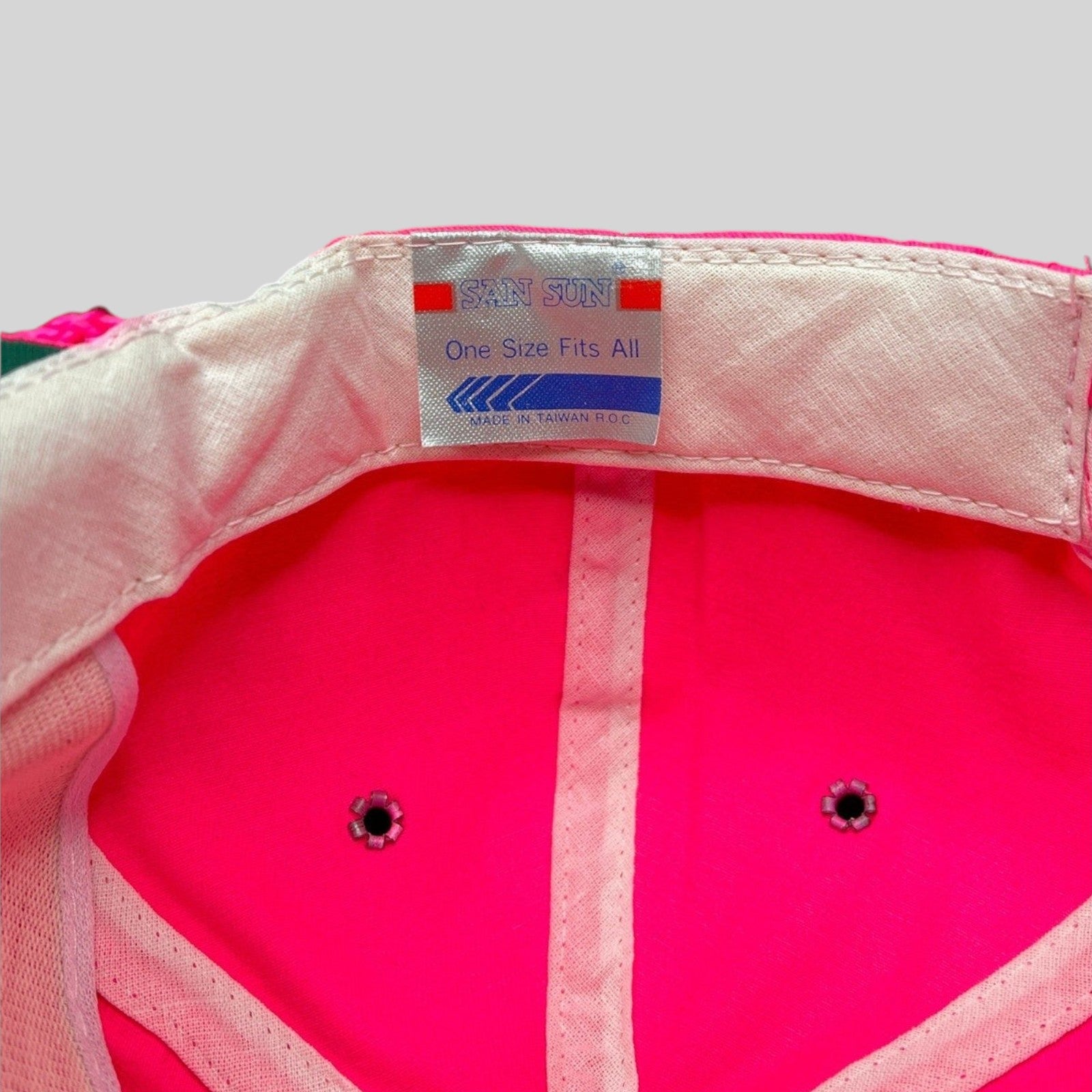 Raree Finds vintage 1980s San Sun hat interior showing the brand label and neon pink fabric construction