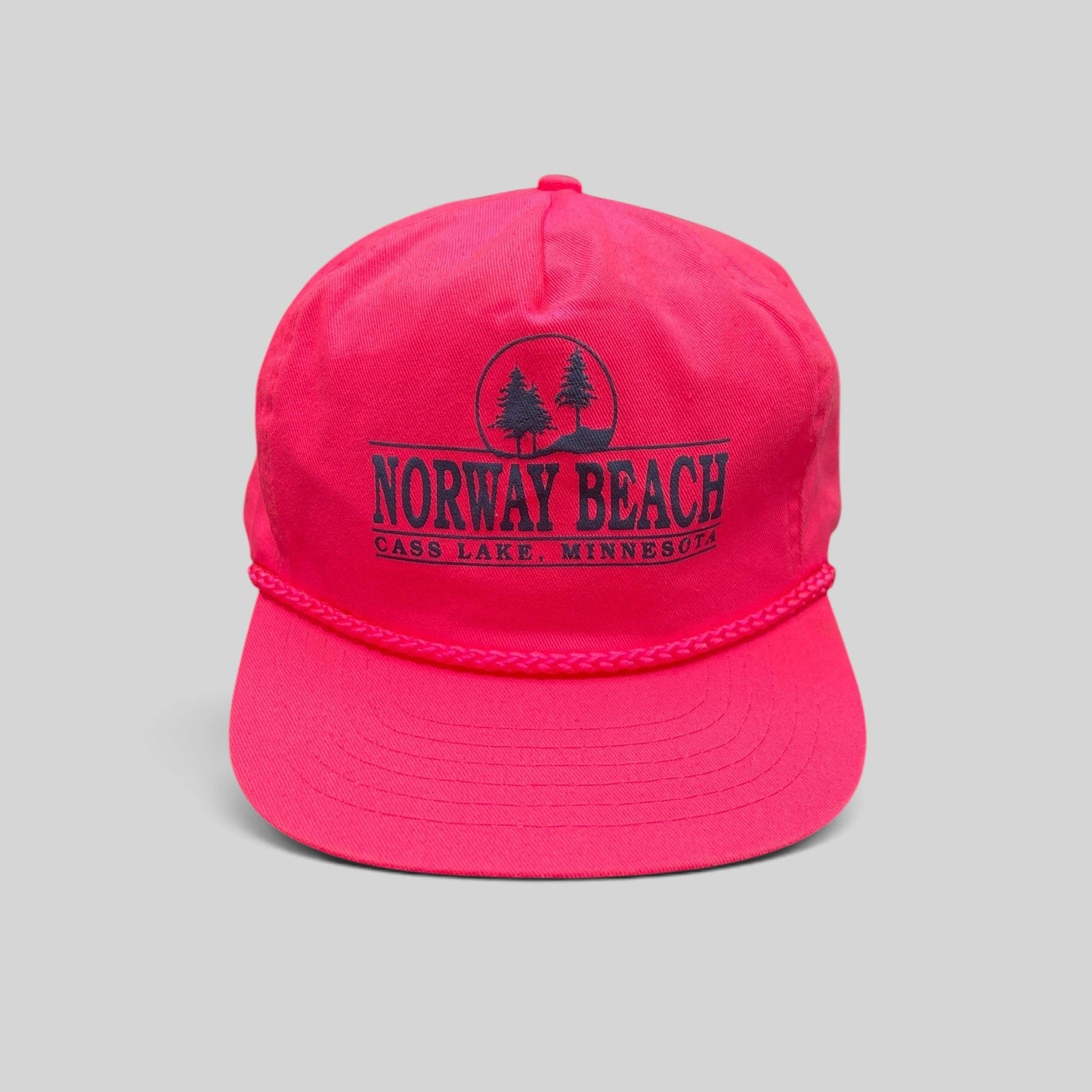 Raree Finds vintage 1980s neon pink snapback hat with navy Norway Beach graphic and decorative front braided rope.