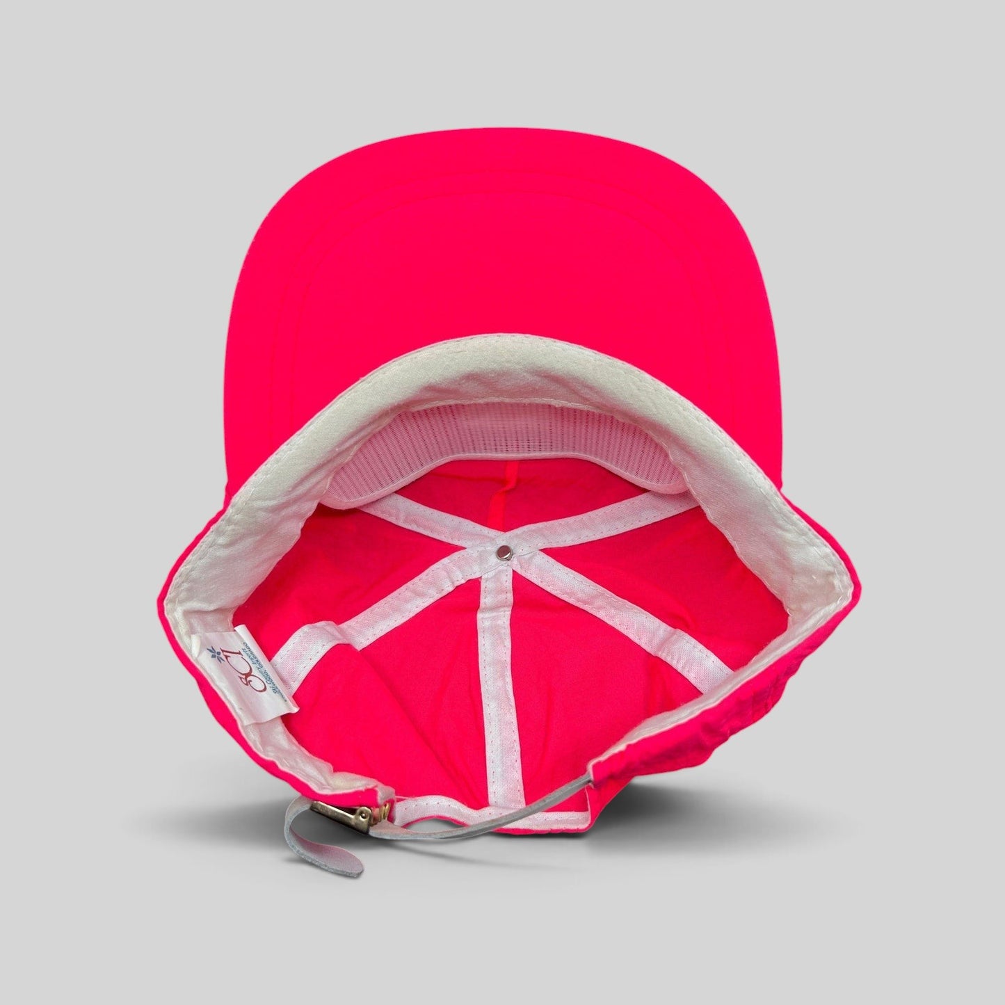 Raree Finds vintage 80s neon pink nylon ski hat with white interior lining and adjustable metal clasp strap