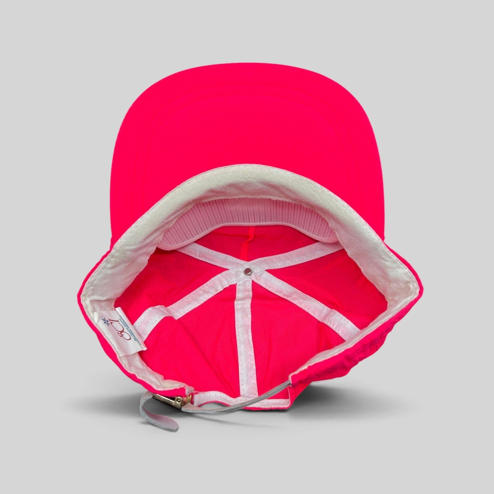 Raree Finds vintage 80s neon pink nylon ski hat with white interior lining and adjustable metal clasp strap
