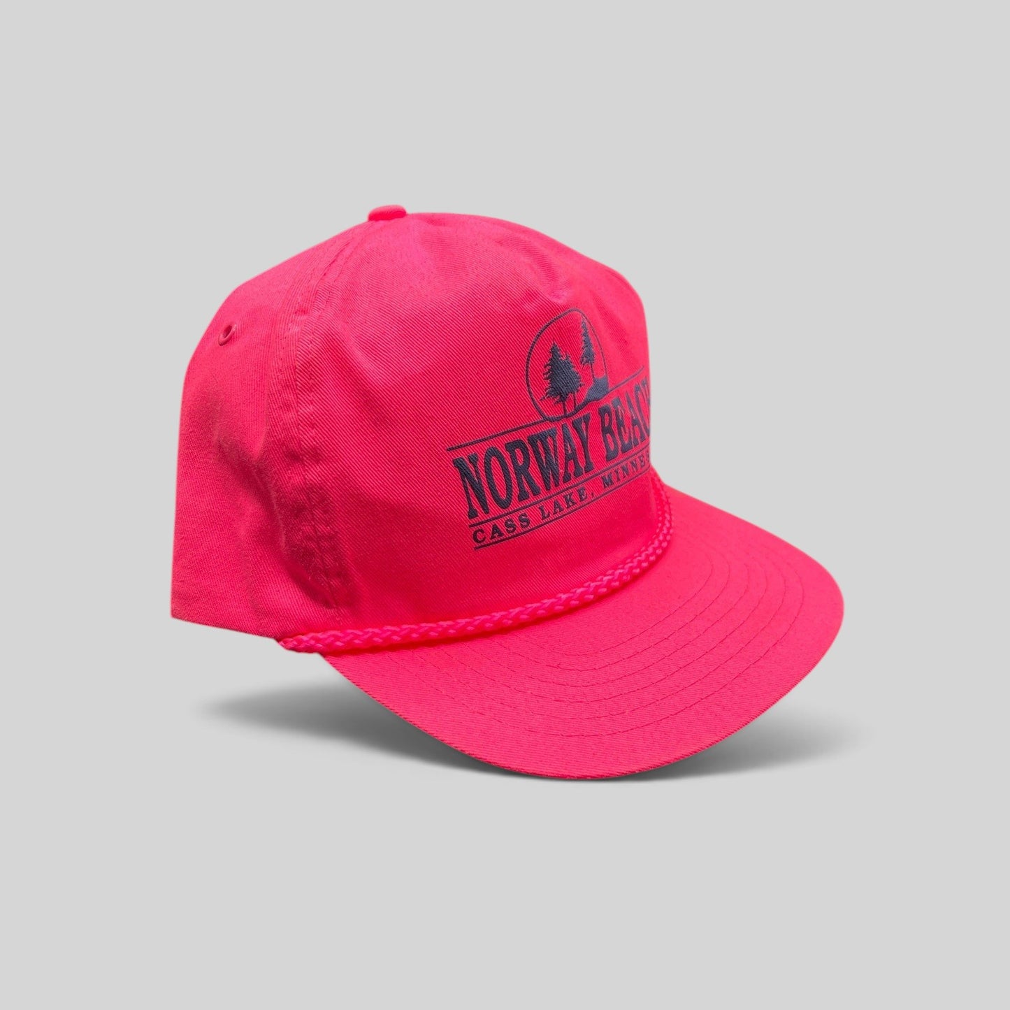Raree Finds vintage 1980s neon pink snapback hat with navy Norway Beach graphic and decorative front rope detail.