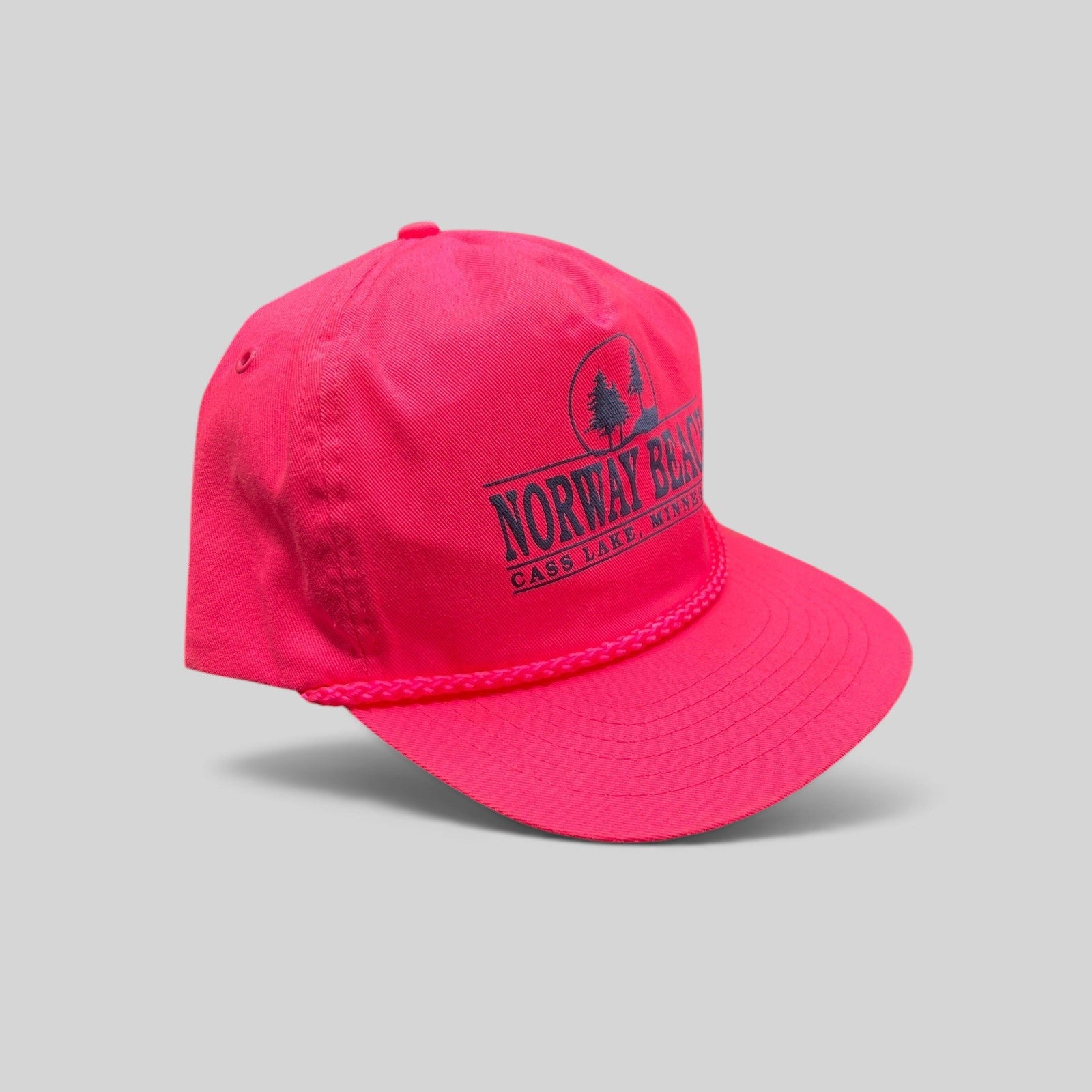 Raree Finds vintage 1980s neon pink snapback hat with navy Norway Beach graphic and decorative front rope detail.