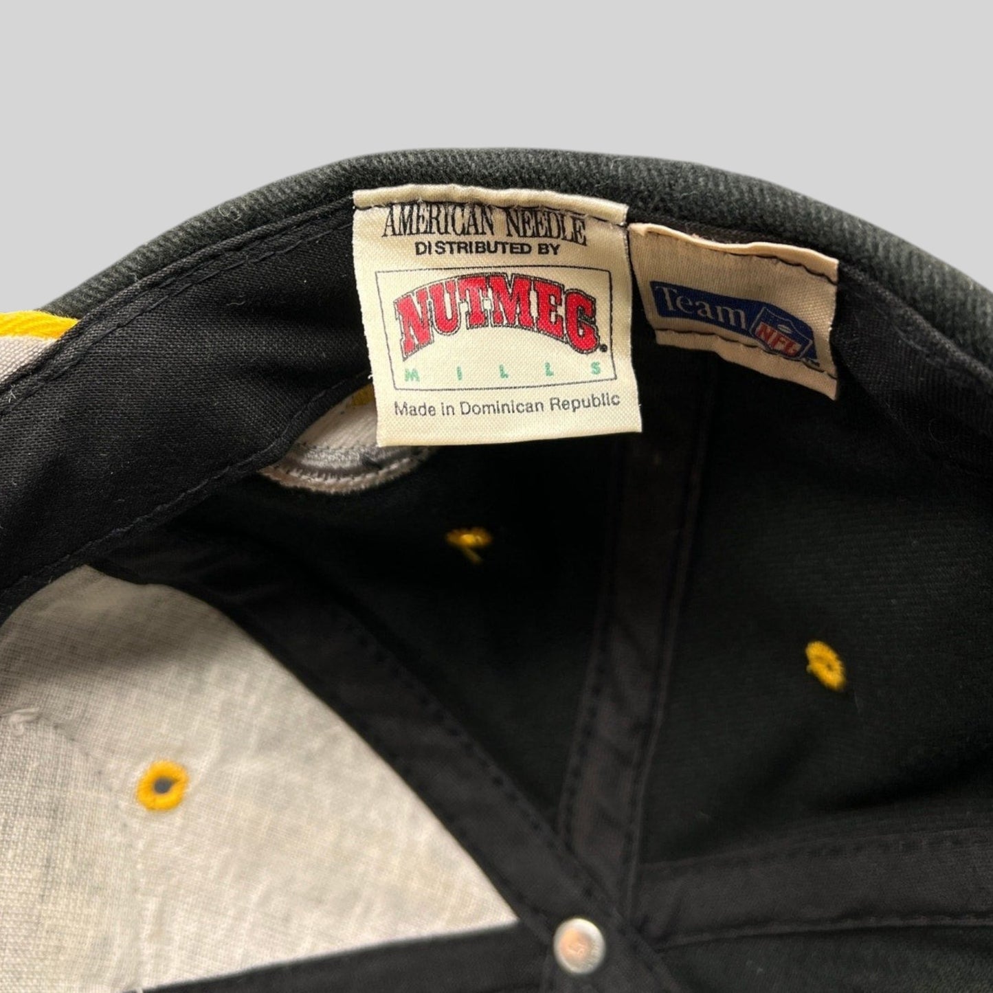Raree Finds vintage Nutmeg Mills and American Needle hat interior labels showing Team NFL branding