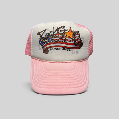 Raree Finds vintage Rockstar Energy Drink trucker hat with white foam front, pink mesh back, and American flag logo.