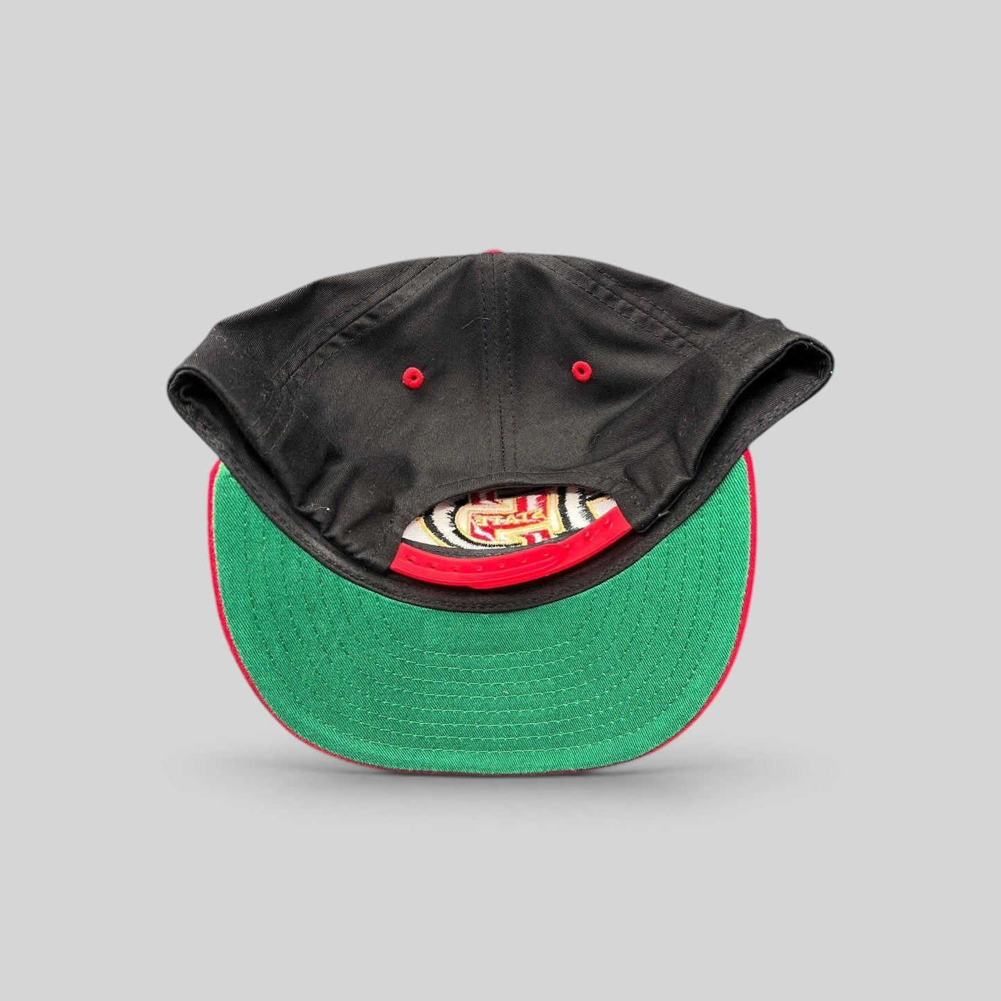 Raree Finds vintage San Diego State Aztecs snapback hat in black and red with a green undervisor and snap closure.