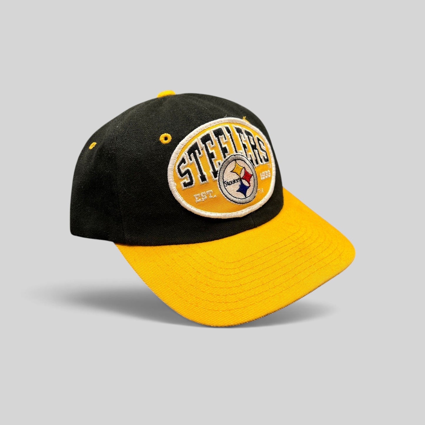 Raree Finds vintage 1990s Pittsburgh Steelers snapback hat with a black crown, gold visor, and embroidered team patch.