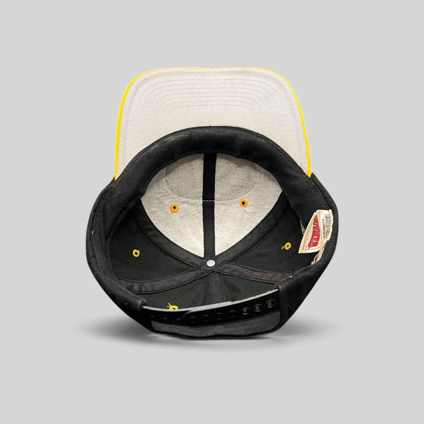 Raree Finds vintage 1990s Pittsburgh Steelers snapback hat interior showing gray underbrim and Nutmeg Mills branding