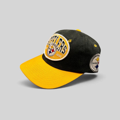 Raree Finds vintage 1990s Pittsburgh Steelers snapback hat with black crown, gold visor, and embroidered team patch.