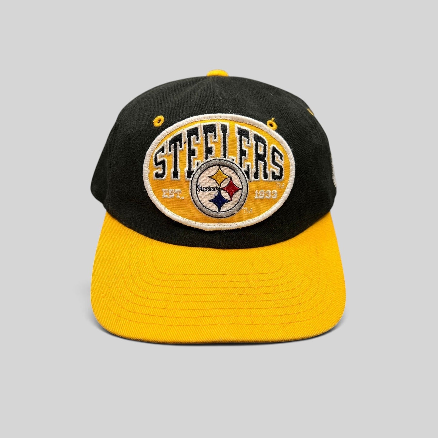 Raree Finds vintage 1990s Pittsburgh Steelers snapback hat with black crown, gold visor, and embroidered team patch.