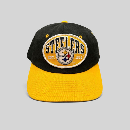 Raree Finds vintage 1990s Pittsburgh Steelers snapback hat with black crown, gold visor, and embroidered team patch.