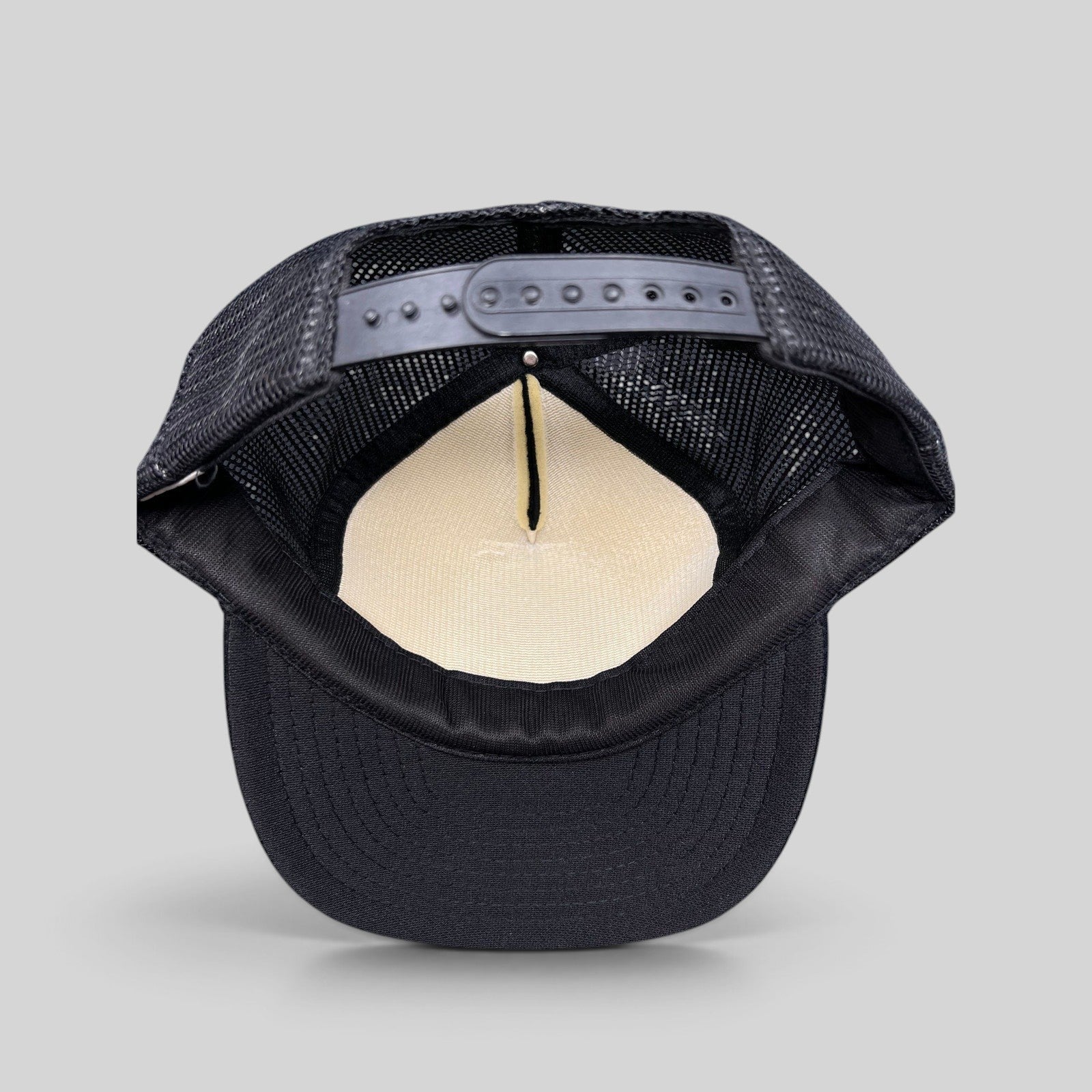 Raree Finds vintage 1989 The Who trucker hat interior view showing black mesh back, foam lining, and snapback closure.