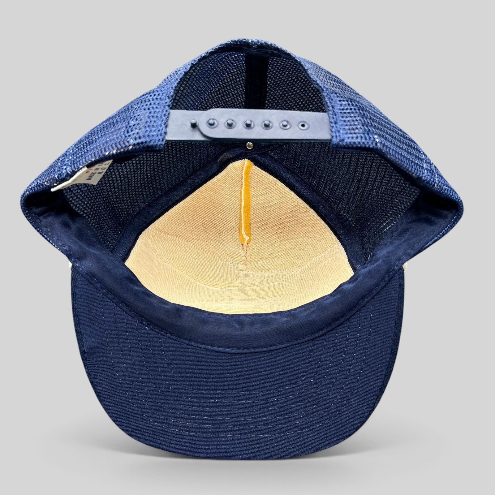 Raree Finds vintage Beverly Hills Gun Club trucker hat interior showing navy mesh back, snapback, and foam crown.