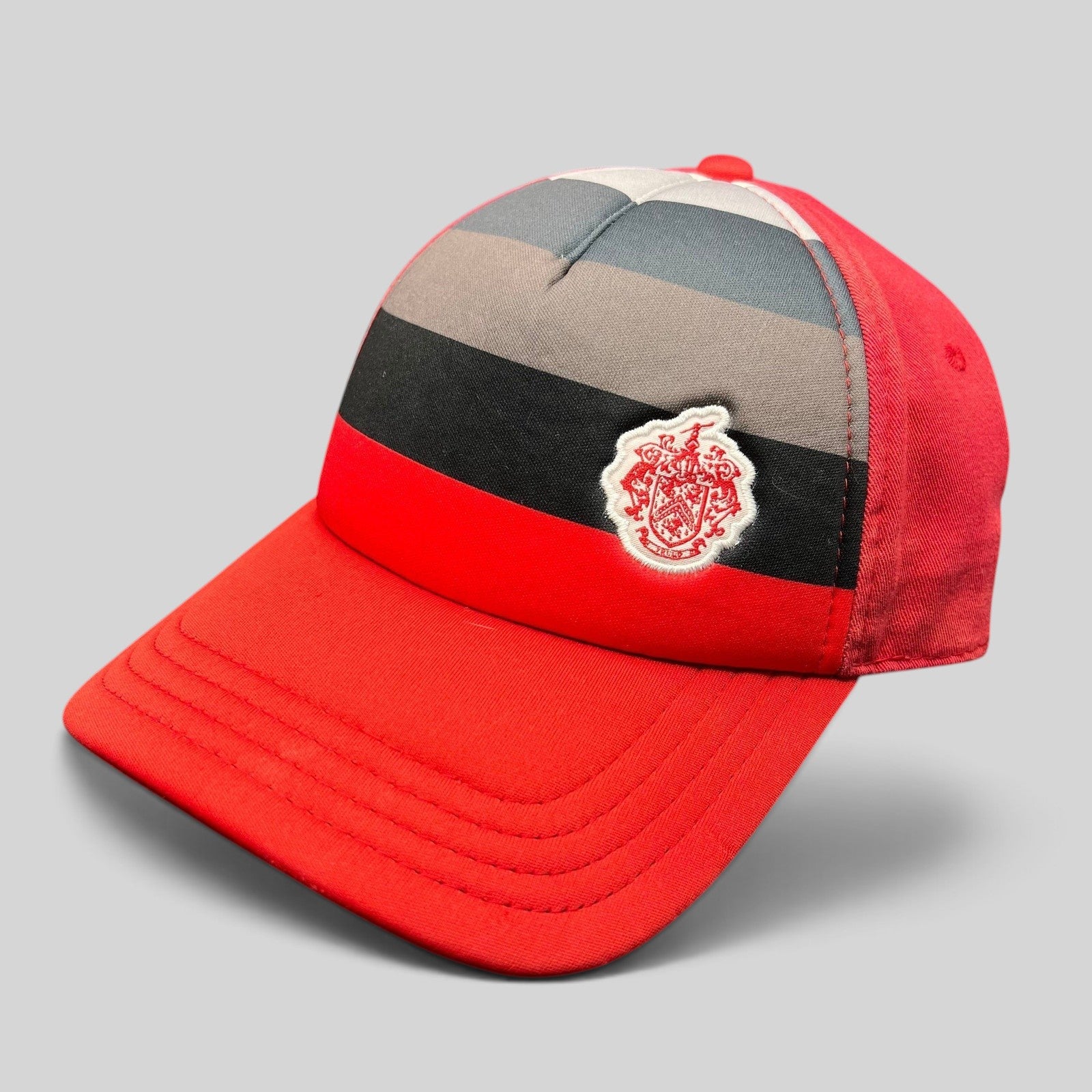 Raree Finds vintage Pukka Headwear Trump National Golf Club strapback hat in red with black and gray striped front.