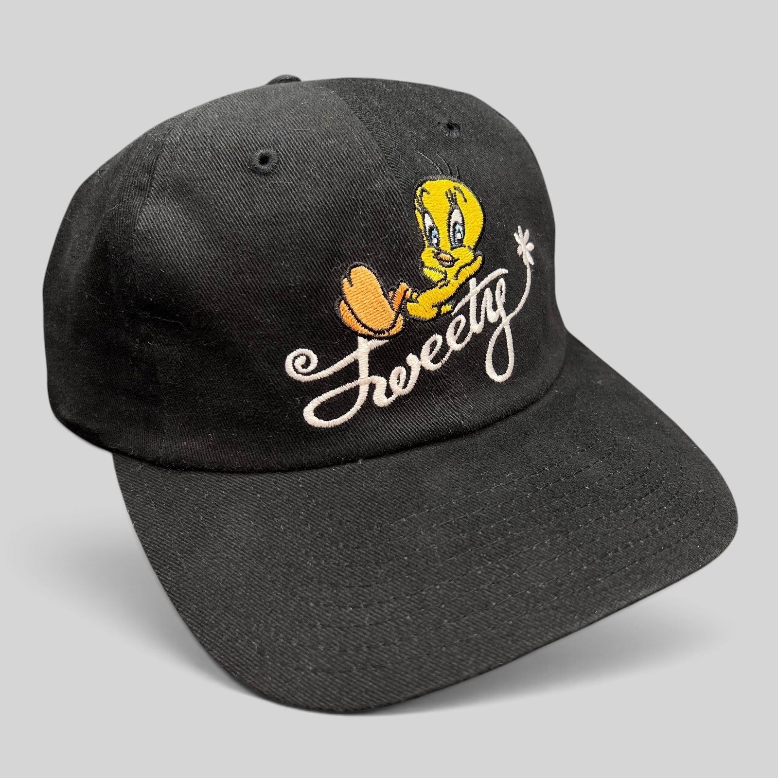 Raree Finds vintage 1998 Warner Bros Studio Store black cotton strapback hat with embroidered Tweety Bird logo