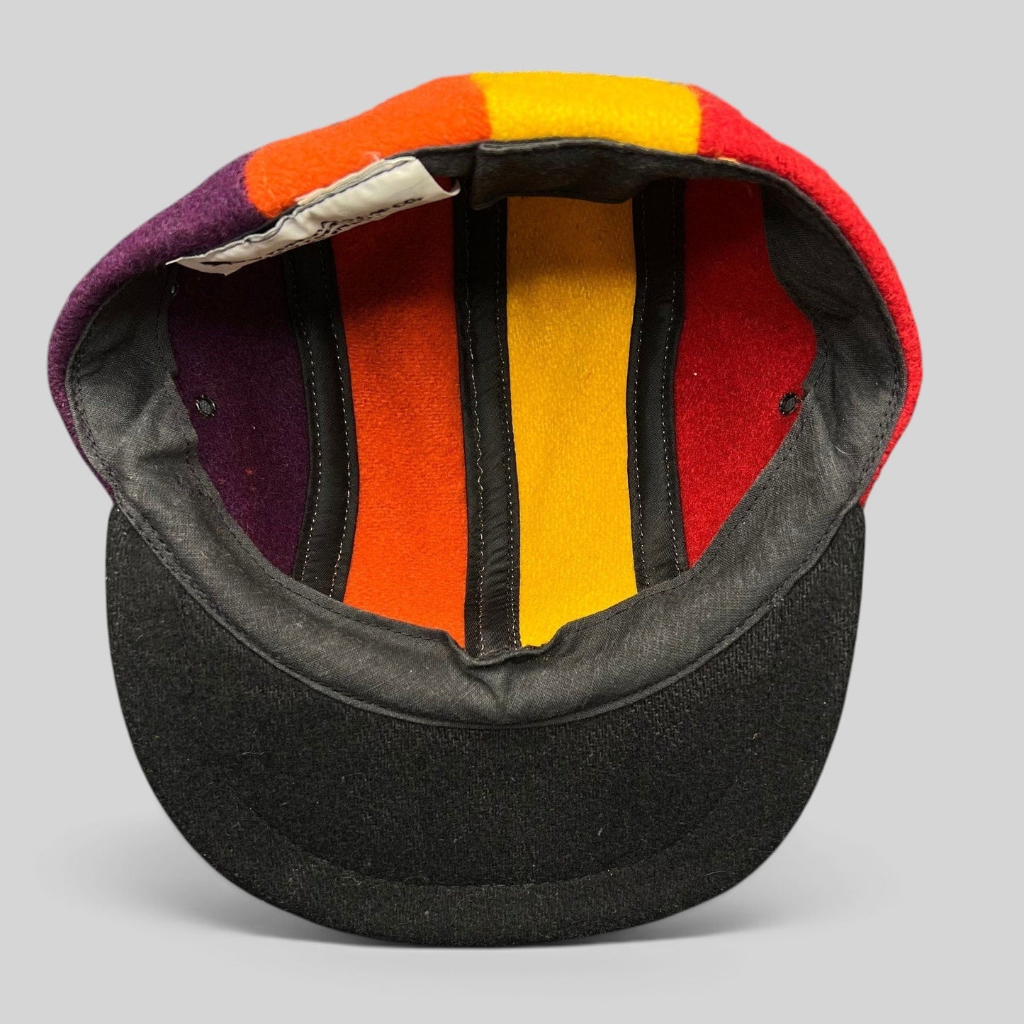Raree Finds vintage 1980s New York Hat Co wool fitted cap featuring a multi-color block design and black brim.