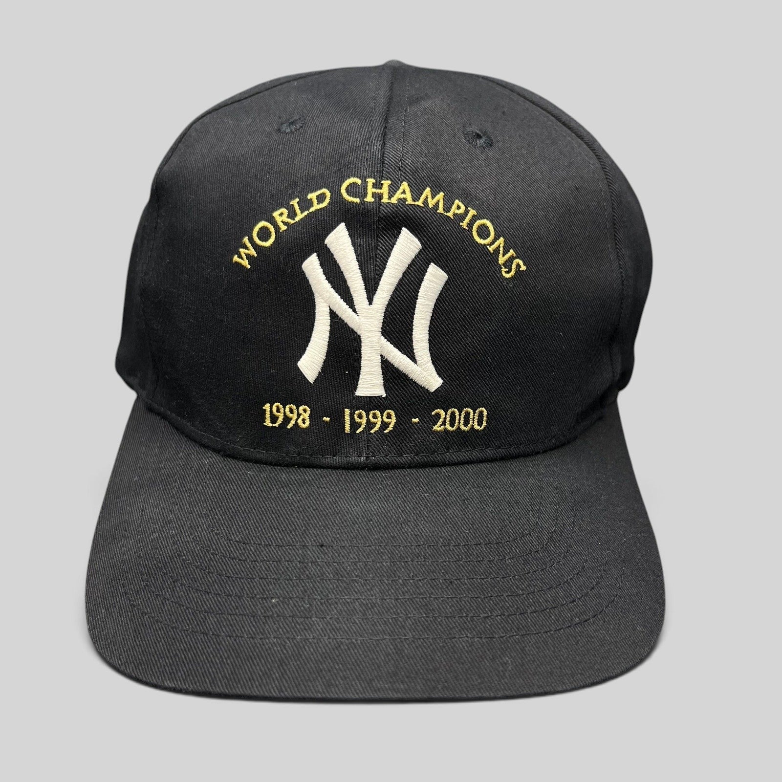 Raree Finds vintage black New York Yankees 3-peat World Champions snapback hat with white and gold embroidery.